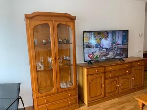 a wooden entertainment center with a flat screen tv at Apartamento Bella Vista in Suances