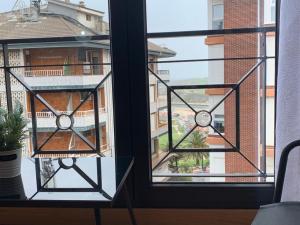 a window with a view of a building at Apartamento Bella Vista in Suances