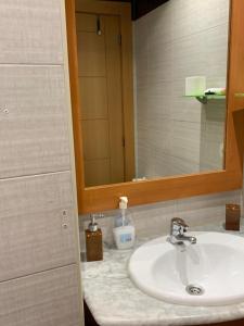 a bathroom with a sink and a mirror at Apartamento Bella Vista in Suances