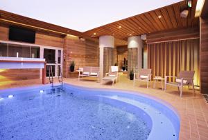 a large swimming pool in the middle of a building at Hotel Aateli Hillside in Vuokatti