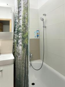 a bathroom with a shower with a shower curtain at BeTree in Bratislava