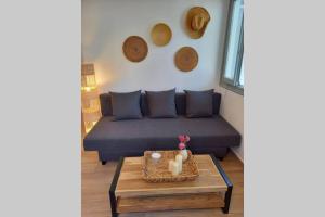a living room with a couch and a coffee table at Patmos Little Suites in Skala