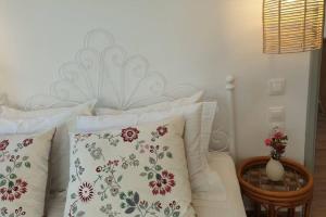 a bedroom with a white bed with pillows at Patmos Little Suites in Skala
