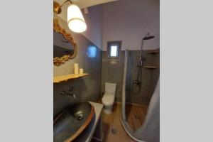 a bathroom with a sink and a shower and a toilet at Patmos Little Suites in Skala