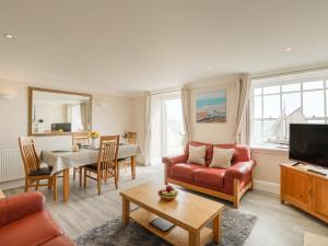 uma sala de estar com um sofá e uma mesa em Ocean Wave em Weymouth