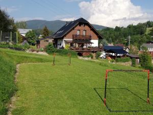 a field with a house and a goal at Apartmány Ester in Rokytnice nad Jizerou