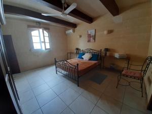 a bedroom with a bed and a window at In-Nuffara Farmhouse, Nadur Gozo in Nadur