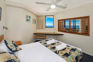 a bedroom with a bed and a window at Ocean Boulevard in Alexandra Headland