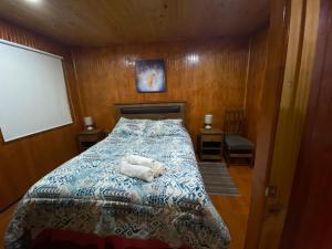 a bedroom with a bed with two towels on it at Depto N°1 Temuco Centro in Temuco