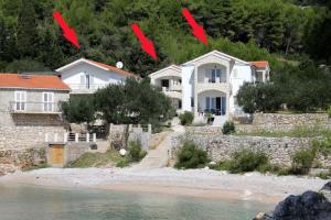 a house on the shore of a beach with four points at Seaside secluded apartments Cove Jedra, Hvar - 2583 in Gdinj