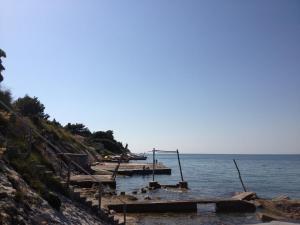 a beach with a group of boats in the water at Guest House Laura in Crveni Vrh