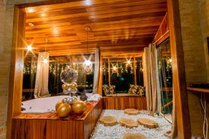 a bathroom with a tub and a christmas tree at Pousada Chale Luiz in Santo Antônio do Pinhal