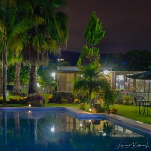 a house with a swimming pool at night at Hotel Boutique Bacaanda in Tepoztlán