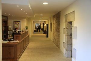 a hallway of a building with a hallwayngth at Hospedería San Martín Pinario in Santiago de Compostela