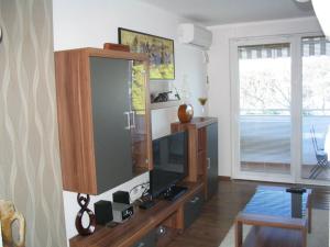 a living room with a tv and a cabinet at Apartment Oliva in Fažana