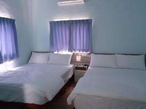 Postel nebo postele na pokoji v ubytování Yueli Homestay