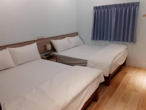 Postel nebo postele na pokoji v ubytování Yueli Homestay