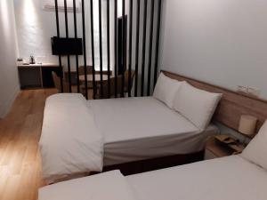 Postel nebo postele na pokoji v ubytování Yueli Homestay