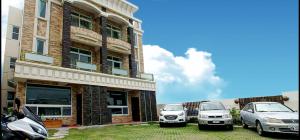 two cars parked in front of a building at Knight Inn in Taitung City