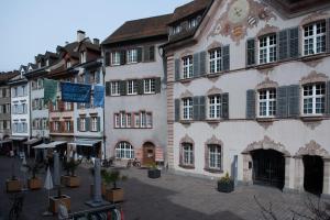 a group of buildings on a street in a city at Unterkunft "Rathaus" Altstadt, Rheinfelden Schweiz in Rheinfelden
