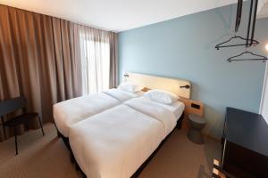 Postel nebo postele na pokoji v ubytování ibis Styles Bayreuth + 18 fotografií
