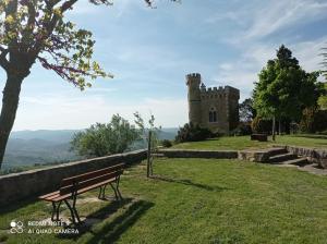 a park bench in front of a castle at Au Village in Rennes-le-Château