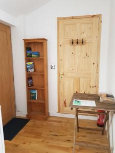 a room with a wooden door and a table at Little Mill, Harbertonford, Totnes. - Entire place. in Totnes