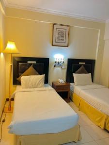 Кровать или кровати в номере Al Nakheel Hotel Apartments