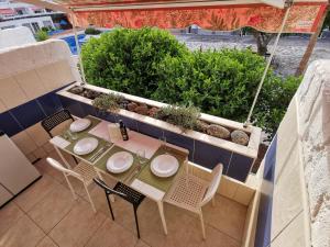 a table and chairs on top of a patio at Casa Maggiore di 3 lovely apt Costa del Silencio in Costa Del Silencio
