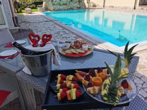 a table with a tray of food and a plate of fruit at Residenza Nosy Be in Palombara Sabina