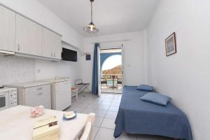 a kitchen with a bed and a table in a room at Villa 9 Muses in Vári