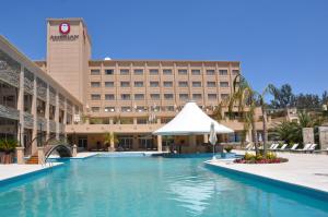 a hotel with a swimming pool in front of a building at Gran Amérian Carlos V in Termas de Río Hondo