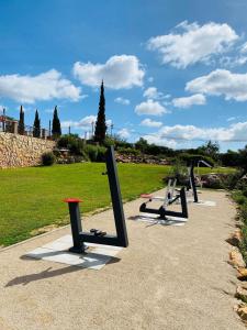 a row of benches sitting in a park at Quinta dos Poetas Nature Hotel & Apartments in Olhão