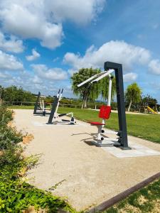 a row of playground equipment in a park at Quinta dos Poetas Nature Hotel & Apartments in Olhão