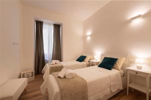 a bedroom with two beds and a window at Nel cuore di Orvieto in Orvieto +17 photos