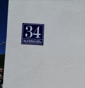 a blue and white sign on the side of a building at Studio Apartman Irena 2 in Bijela