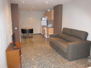 a living room with a couch and a kitchen at Apartamentos Abastos in Valencia