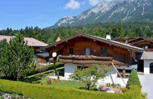 a house with a mountain in the background at Ferienwohnung Steiner in Scheffau in Scheffau am Wilden Kaiser