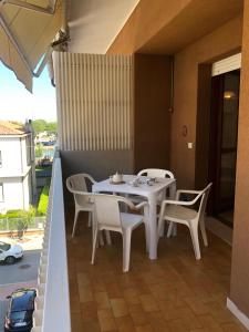 a white table and chairs on a balcony at Villa Nadia in Grado