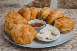 a plate of food with biscuits and dipping sauce at Lakeview Apartments Anđela in Virpazar