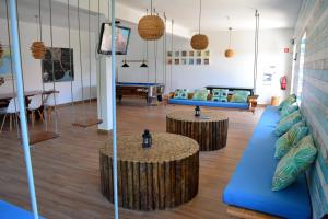 a living room with blue couches and a table at Sagres Natura in Sagres