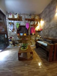 een kamer met een tafel en een bank en planken bij Pousada A Casinha in Icaraí