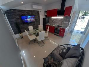 a living room with a table and chairs and a kitchen at Anita Prižba in Prizba
