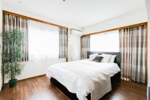 Postel nebo postele na pokoji v ubytování GuestHouse MIYABI