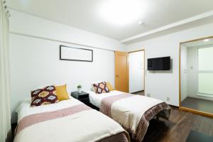Postel nebo postele na pokoji v ubytování GuestHouse MIYABI