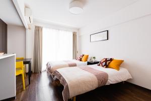 Postel nebo postele na pokoji v ubytování GuestHouse MIYABI