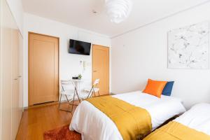 Postel nebo postele na pokoji v ubytování GuestHouse MIYABI
