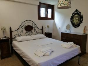 a bedroom with a large bed with two towels on it at Villa Thea in Ancient Epidauros