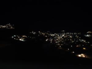 a view of a city at night with lights at SUNRISE VIEW Apartment 2 in Rámos +1 photo