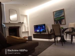 a living room with a tv and a fireplace at Dimora50 Apartament in Porto Recanati